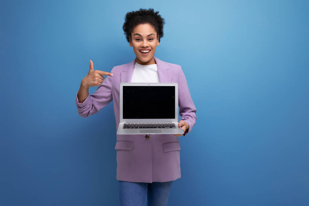 jeune hispanique intelligente brune leader femme avec les cheveux bouclés en veste utilise ordinateur portable pour les affaires. - Photo, image