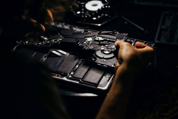 Mans hands repairing the laptop - Foto, Bild