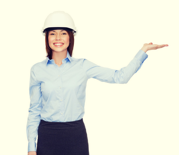 businesswoman in helmet holding something on palm - Foto, Imagem
