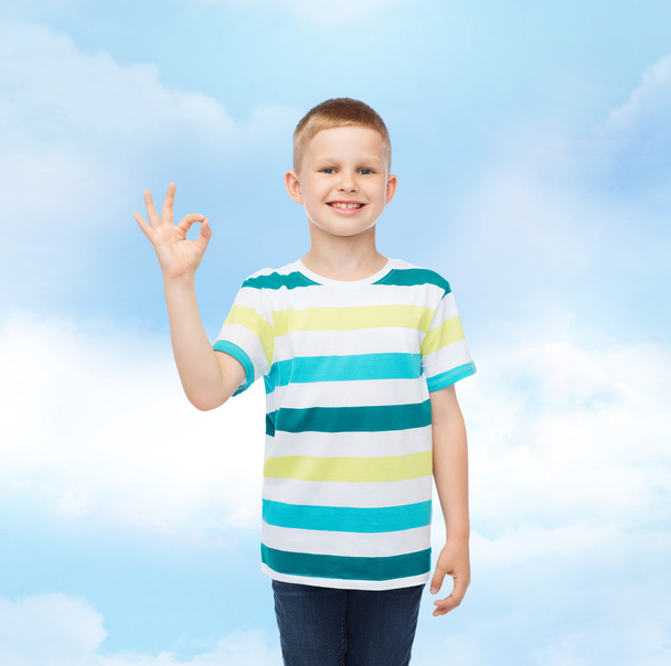 little boy in casual clothes making ok gesture - Фото, изображение