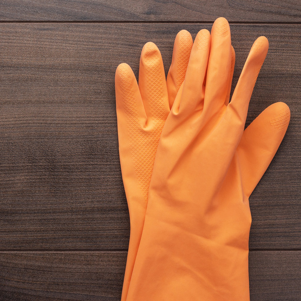 orange rubber cleaning gloves - 写真・画像