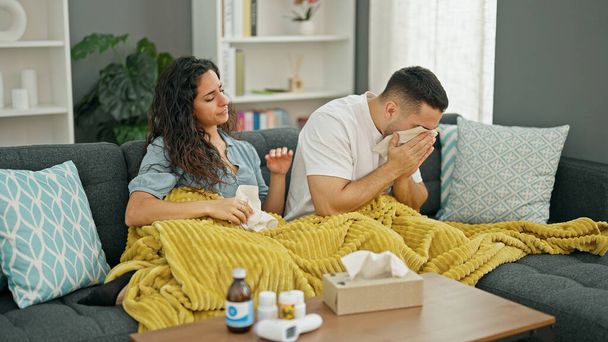 Man and woman couple being sick sneezing at home - Photo, Image