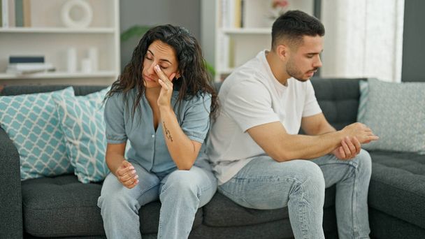 Man and woman couple sitting on sofa arguing stressed at home - Photo, Image
