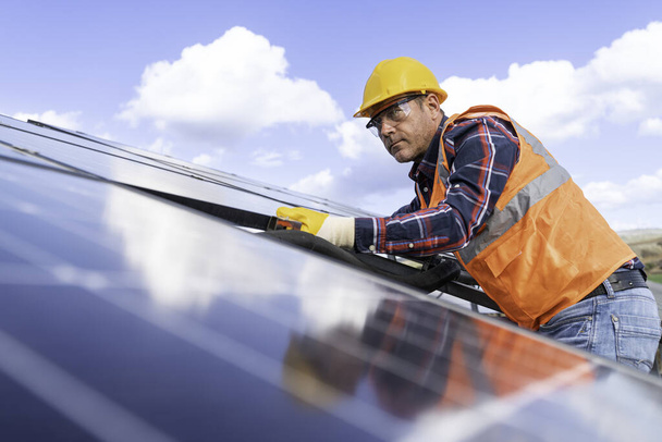 man with installation of solar panels make on solar panel plant. - Photo, Image