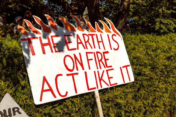 地球が火にかけられているサインの眺め,バンクーバーの世界気候ストライキの一環としての行動 - 写真・画像