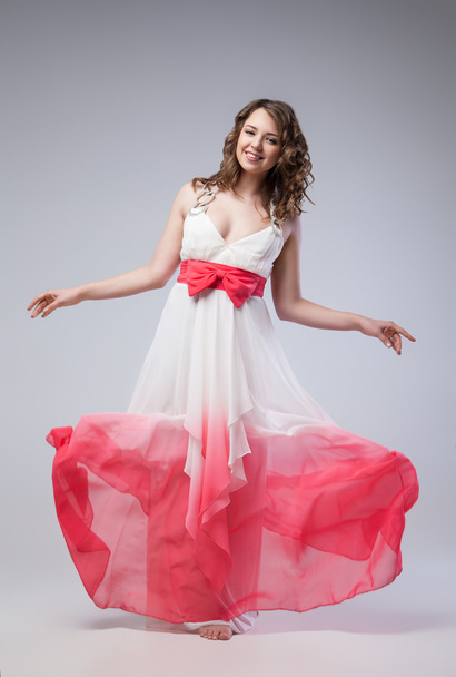 Elegant girl in fluttering dress - Zdjęcie, obraz