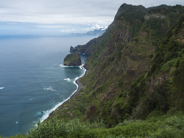 Scenic koholla näkymä kohti Rocha do Navio Reserve ja Ponta de Catarina Pires viitta. Valtameri, trooppinen vihreä kasvillisuus, kalliot ja vesiputous. Portugali, Madeira, Santana - Valokuva, kuva