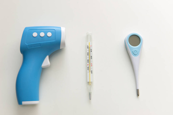 Best Thermometer for home. Three different types of thermometers on white background. Mercury, infrared contactless Thermometer. - Photo, Image