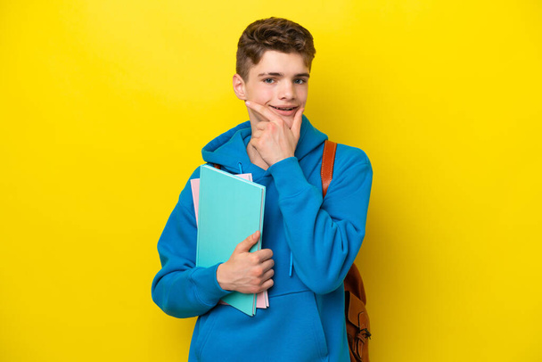 Teenager Russian student man isolated on yellow background happy and smiling - Foto, immagini