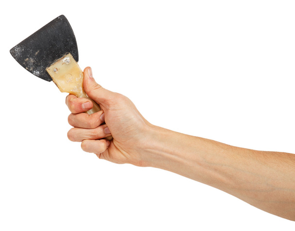 Velha espátula de borracha na mão masculina
 - Foto, Imagem