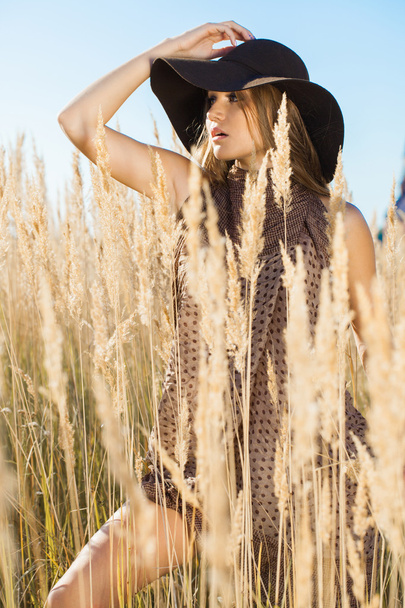 Beautiful lady model walking through meadow wilds - Photo, Image