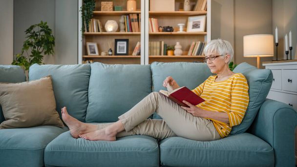 Una mujer madura mayor caucásica pensionista moderna abuela leer libro en casa gafas de desgaste espacio de copia persona real - Foto, Imagen