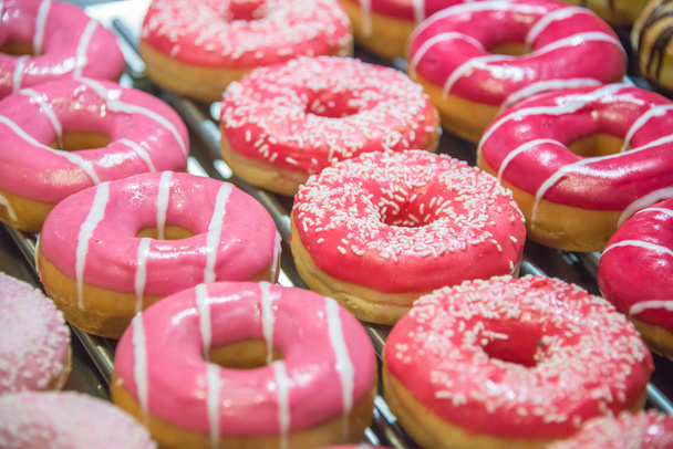 Sweet donuts arranged at display - Photo, Image