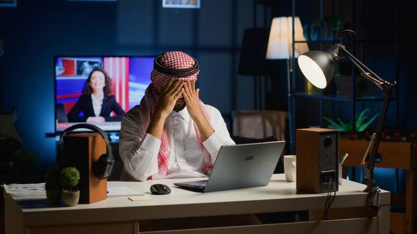 Muslimi yrittäjä kärsii migreeni työskentelee kotoa, kun käytät kannettavaa Lähi-idän mies henkilökohtainen asunto toimistossa vastaamalla sähköposteihin saada päänsärkyä ylitöistä - Valokuva, kuva