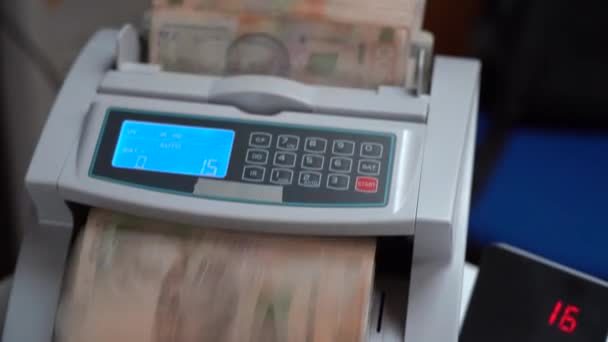 Counting machine for banknotes. Ukrainian money in a calculating machine. Conversion of the Ukrainian currency. Ukrainian money is counted by a machine for banknotes. Ukrainian hryvnia. - Footage, Video