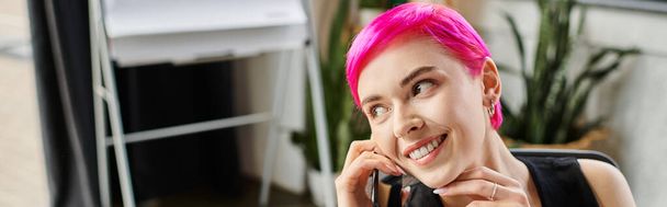 cheerful tattooed woman in casual urban outfit talking by phone at office, business concept, banner - Photo, Image