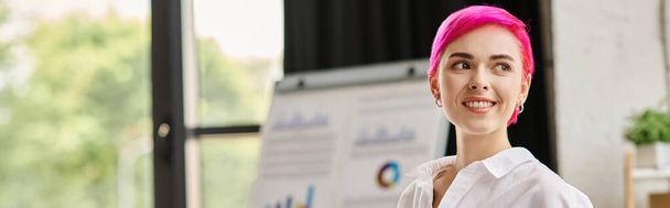 cheerful attractive pink haired female worker in white shirt smiling and looking away, banner - Photo, Image