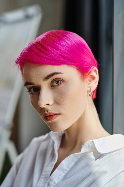 pensive attractive young woman with pink hair posing and looking at camera, business concept - Photo, Image