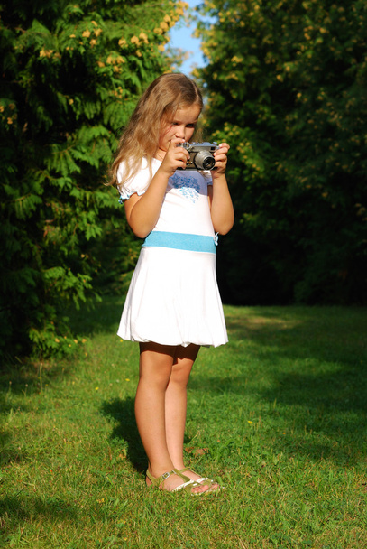 The little girl with the old camera - Photo, image