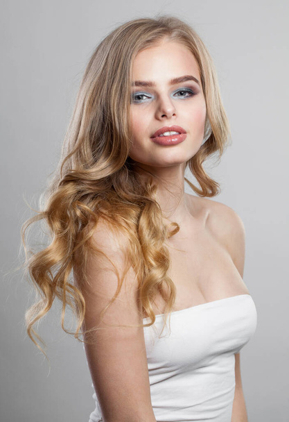 Cheerful female model woman. Fresh skin, trendy makeup and wavy blonde hair - Photo, Image