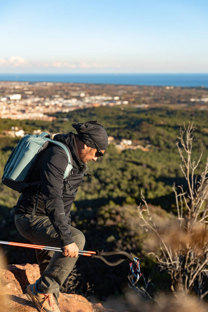 Man descends the mountain surrounded by the landscape of the Garraf Natural Park. - Photo, Image