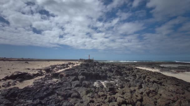Natuurlijke getijdenpoelen van het strand Playa de los Charcos en de vuurtoren van Toston - Natuurlijke poelen van het strand van Los Laguitos of Los Charcos op Fuerteventura, Canarische eilanden, Spanje. 24.09.2023 - Video