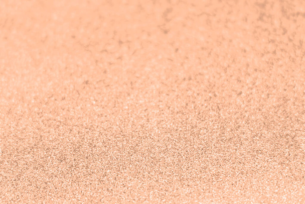 Perzik fuzz, kleur van het jaar golf glanzend glitter papier textuur. Schitterende luxe stof. Glimmerende gouden kleur, kerst achtergrond. - Foto, afbeelding