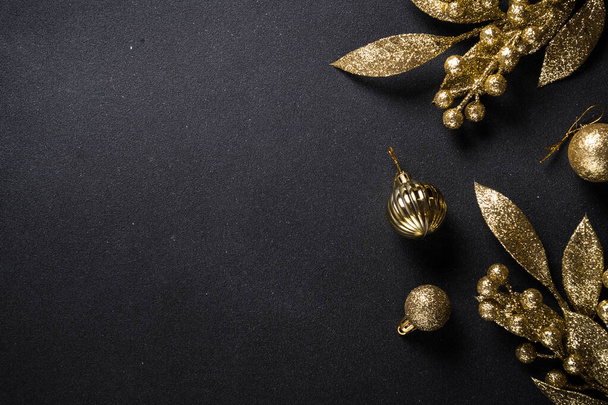 Christmas gold decorations on black background. Top view image with copy space. - Photo, Image