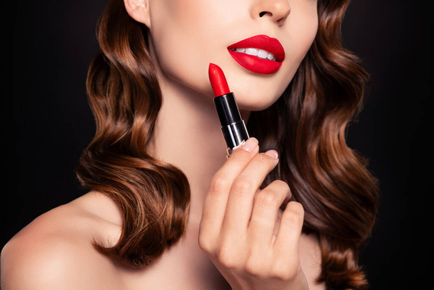 Cropped photo of lady prepare for romantic rich wealthy date applying red glossy pomade on lips over dark background. - Photo, Image