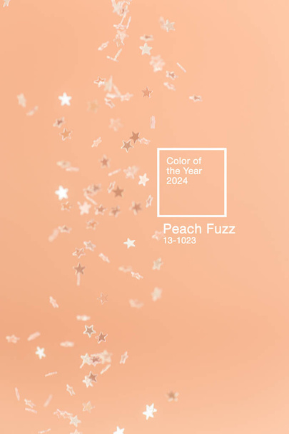 Fondo minimalista abstracto con brillo estrella que cae de color en Peach Fuzz - color del año 2024. - Foto, imagen