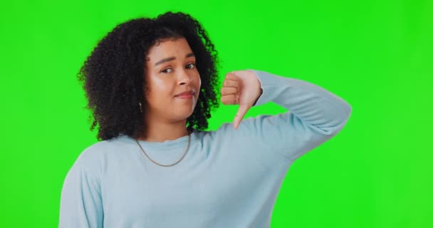 Face, green screen and woman with thumbs down, no opinion and bad review against a studio background. Portrait, female person or model with hand gesture, voting or emoji with choice, feedback or fail. - Footage, Video