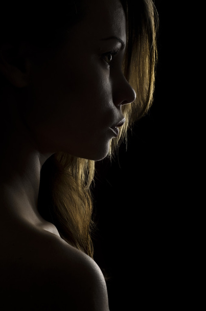 Dark portrait of a girl light. - 写真・画像