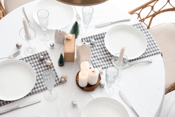 Festive table setting with burning candles and Christmas decor - Photo, Image