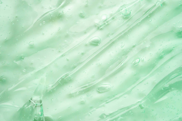 Διαφανές πράσινο υγρό ορό τζελ καλλυντική υφή φόντο - Φωτογραφία, εικόνα