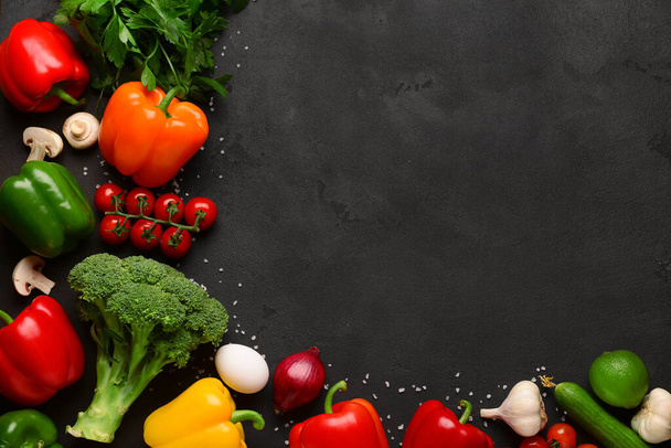 Fresh vegetables, fruits and mushrooms on black background - Photo, Image