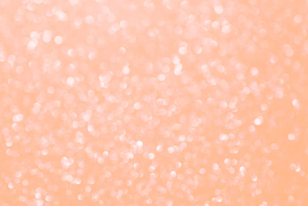 Peach fuzz csillogó csillogó bokeh háttér, elvont disocused textúra. Ünnepi fények. Az év színe 2024 - Fotó, kép