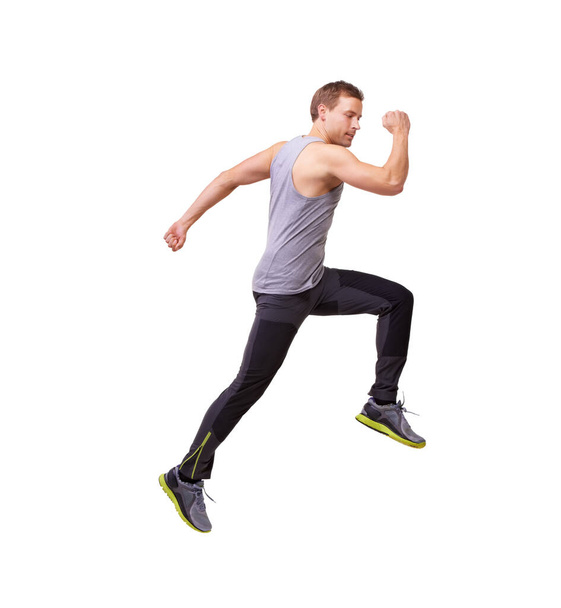Man, läuft und springt in Fitness, Workout und Training im Studio mit Wellness und Energie oder Schnelligkeit. Sportmodell, Sprinter oder Läufer in Luft, Bewegung und Ausdauer- oder Muskelgesundheit auf weißem Hintergrund. - Foto, Bild