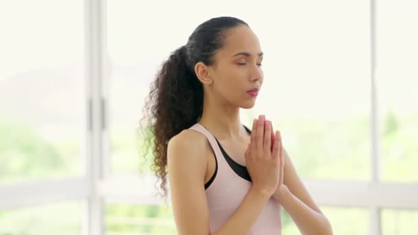 Yoga, prayer hands and meditation of woman in home for mindfulness, exercise or training. Pilates, fitness and person with namaste for zen, chakra and wellness to workout for health, calm and peace - Footage, Video
