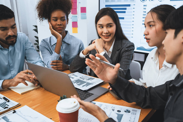 Multiracial analyst team use BI dashboard data to analyze financial report on meeting table. Group of diverse business people utilize data analysis by FIntech for success business marketing. Concord - Photo, Image