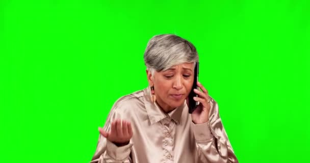 Phone call, fighting and frustrated with a woman on a green screen background in studio arguing on a telephone. Stress, conflict or problem with a senior employee looking angry during a conversation. - Footage, Video