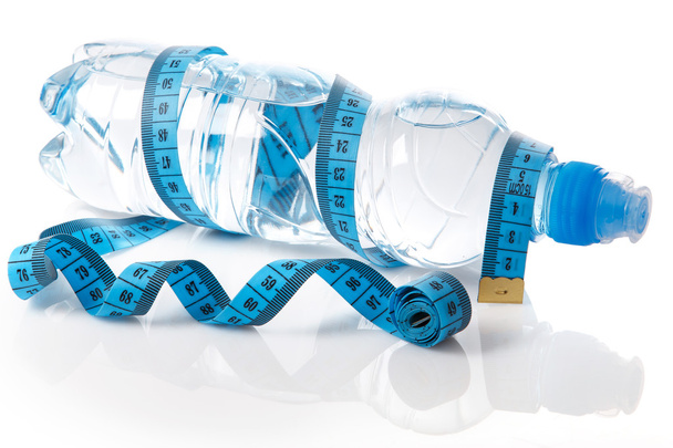 Bottle of water and measure tape - Photo, image