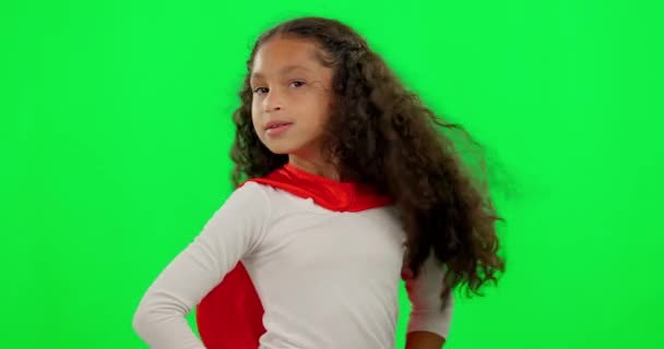 Girl kid, hero and green screen with face, strong and justice with hands on hips for mockup. Young female kid, power and portrait for confidence, red superhero cape and stop crime with hair in wind. - Footage, Video