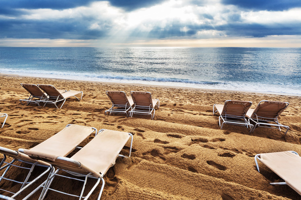 Deck chairs on beach - Foto, afbeelding