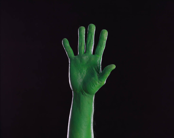 green painted hands on black background - Photo, Image