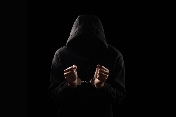 Silhouette of handcuffed male in hoodie, dangerous criminal punished by law - Photo, Image