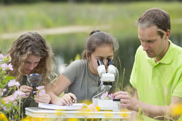 Pretty young girls having outdoor science lesson  exploring natu - Photo, Image