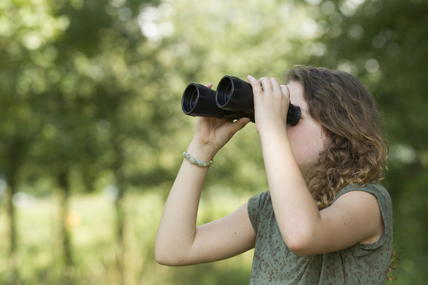 Menina bonita explorando o ambiente com um binocular
 - Foto, Imagem