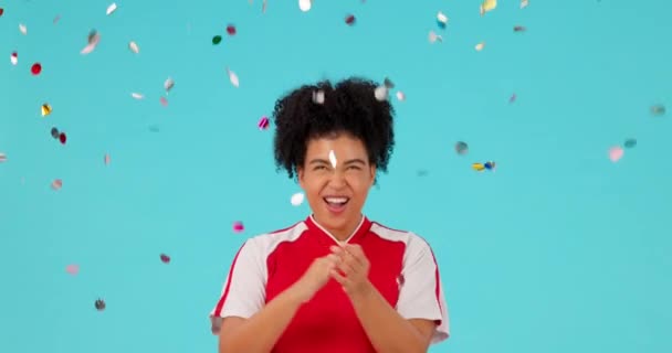 Celebration confetti, applause and woman excited for studio bonus, winning reward or prize giveaway. Success happiness, winner achievement and person clapping, celebrate or smile on blue background. - Footage, Video