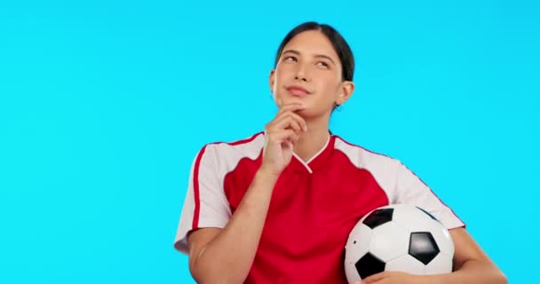 Young woman, soccer and thinking with ball, ideas and vision for career, mindset or face by blue background. Girl, football player and professional sports person with focus, choice and dream on brain. - Footage, Video