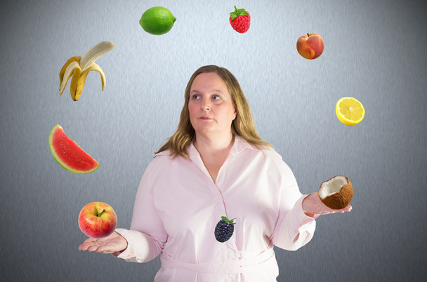 Woman juggles with fruit - Photo, image